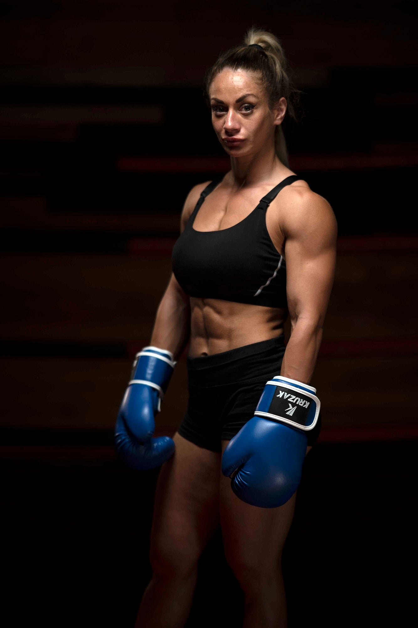 Woman wearing Kruzak Blue boxing gloves