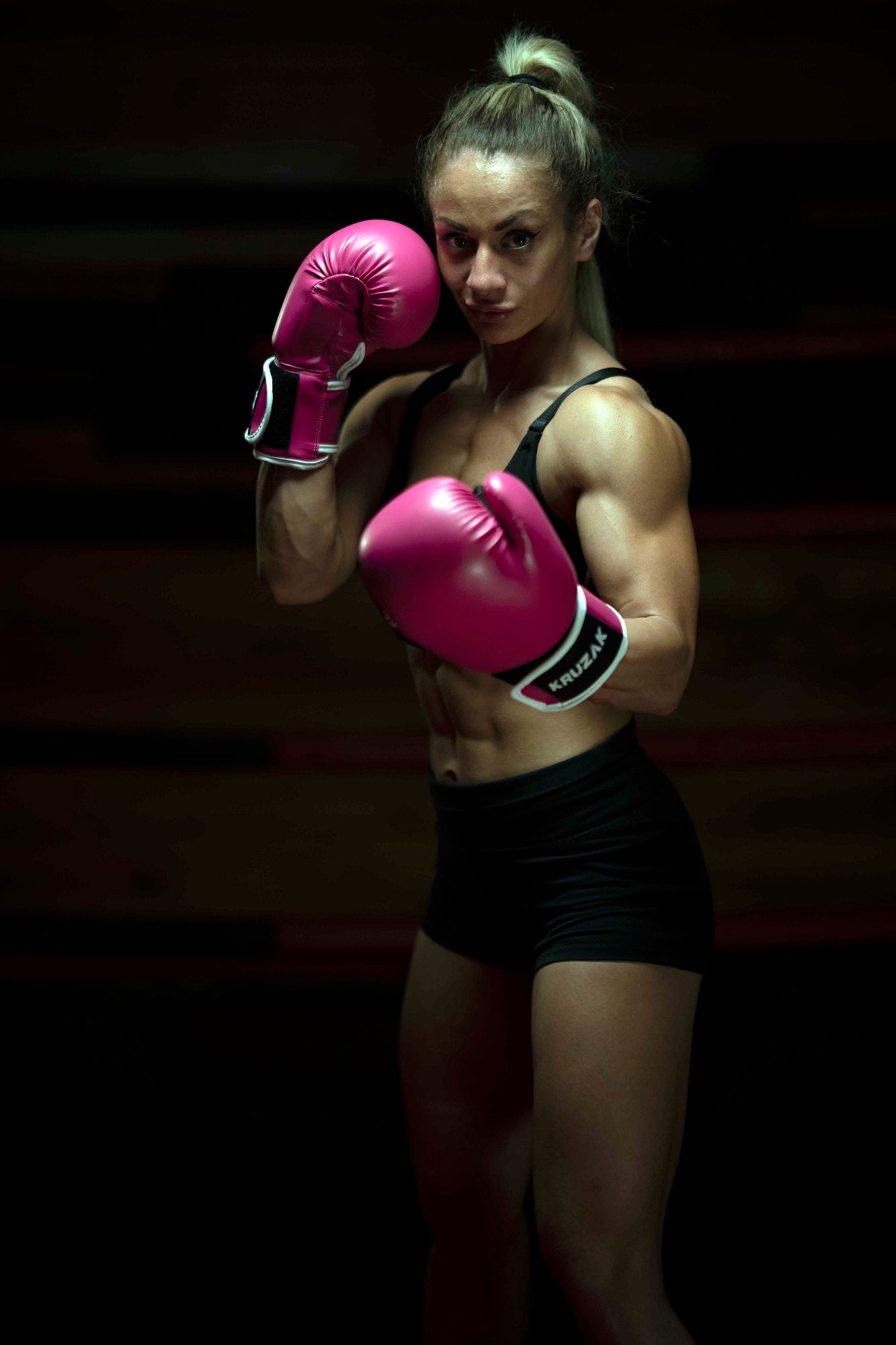 Woman wearing Kruzak Pink boxing gloves