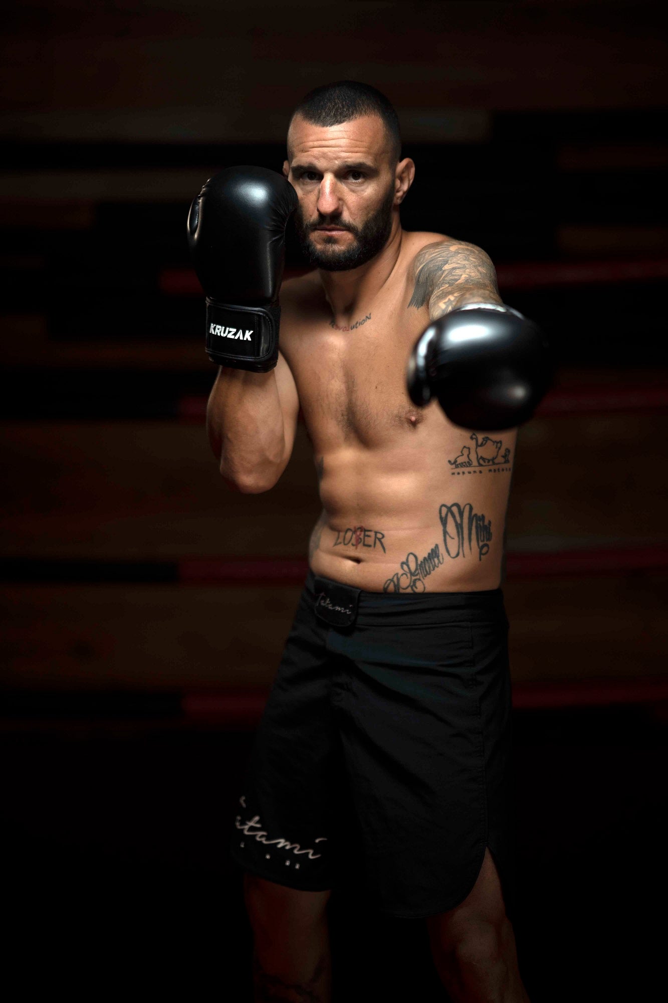 Man wearing Kruzak Black boxing gloves
