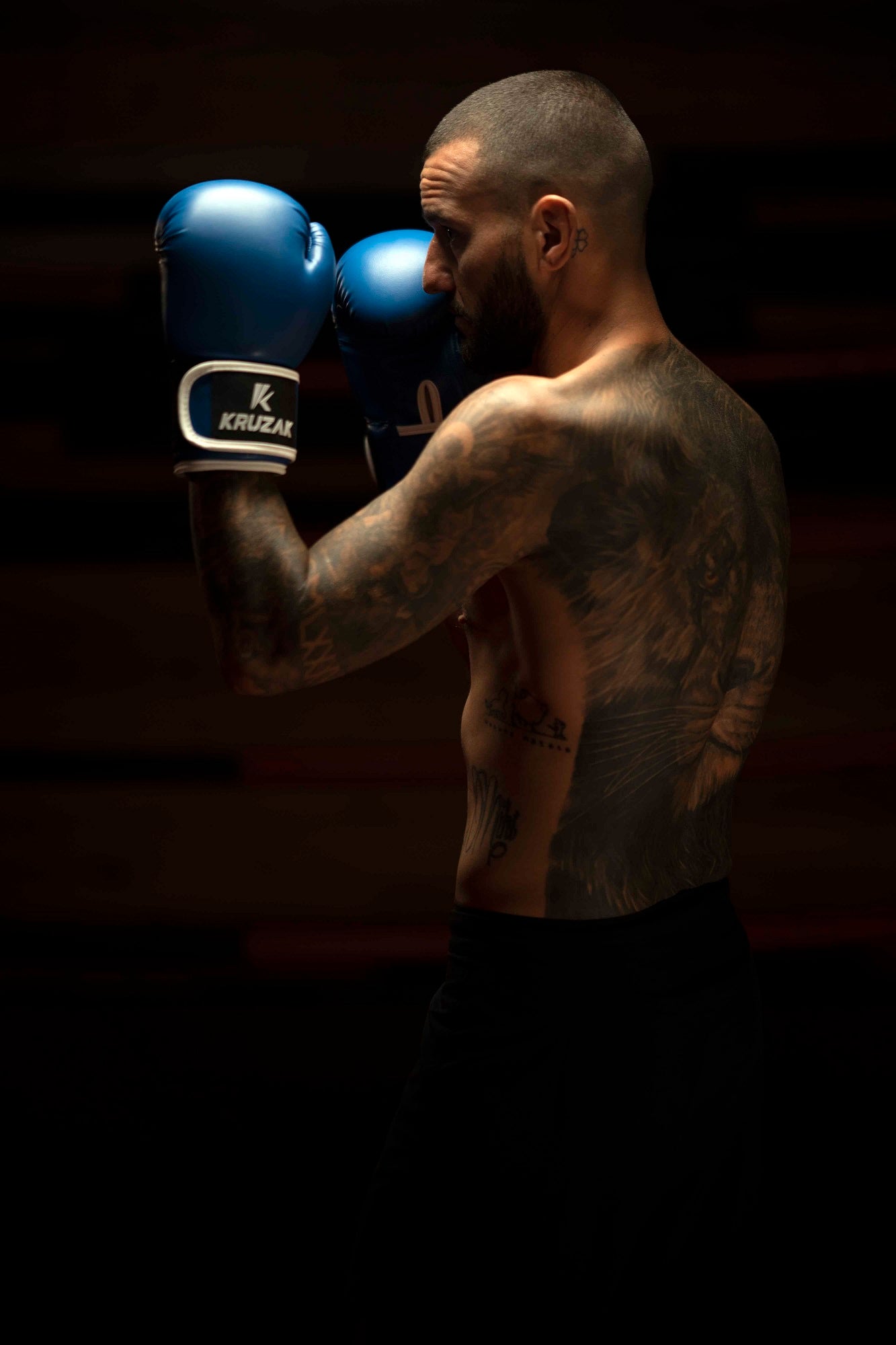 Man wearing Kruzak Blue boxing gloves