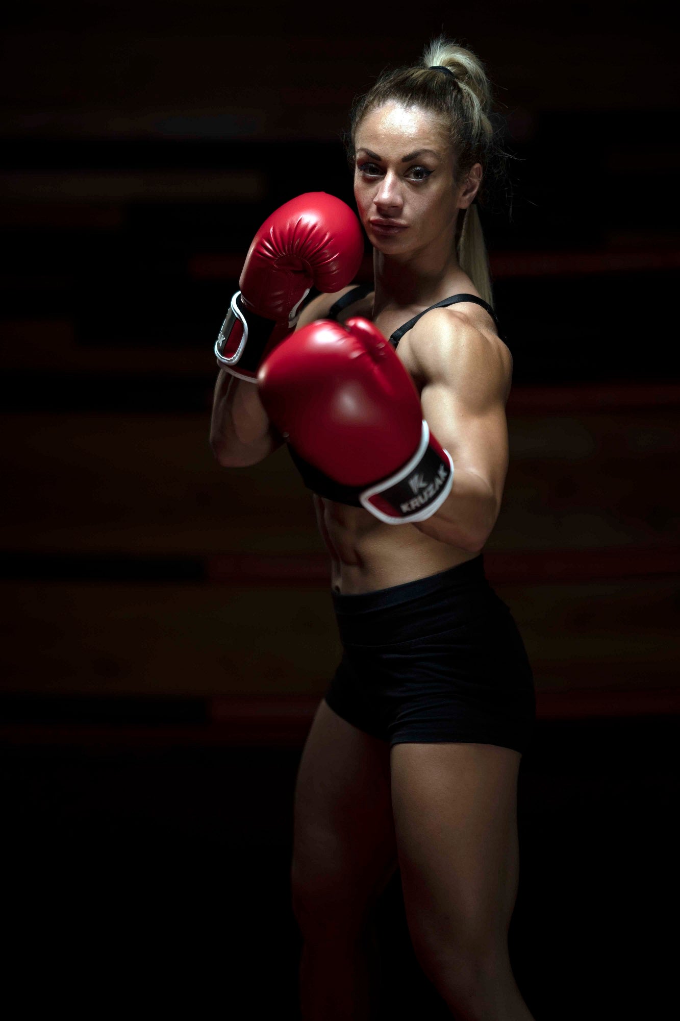 Woman wearing Kruzak Red boxing gloves